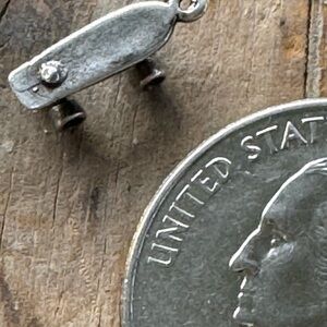 Very small vintage sterling skate board charm.